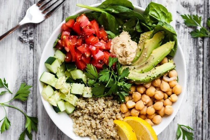 Quinoa Buddha bowl with roasted chickpeas, avocado and tahini dressing